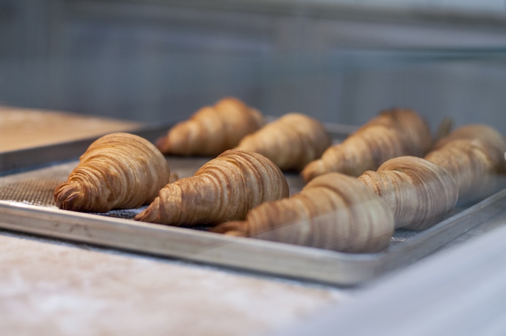 seven croissant on gray metal tray