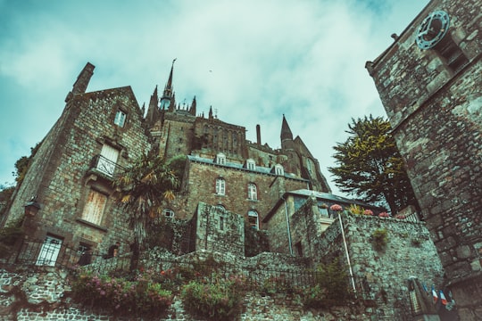 worm's eye view of brown castle in Mont Saint-Michel France