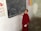 A young person in a red robe is standing by a chalkboard with writings and drawings, such as 'Live to love' and a heart shape. The wall in the background features colorful educational posters with images of flowers and anatomical diagrams.