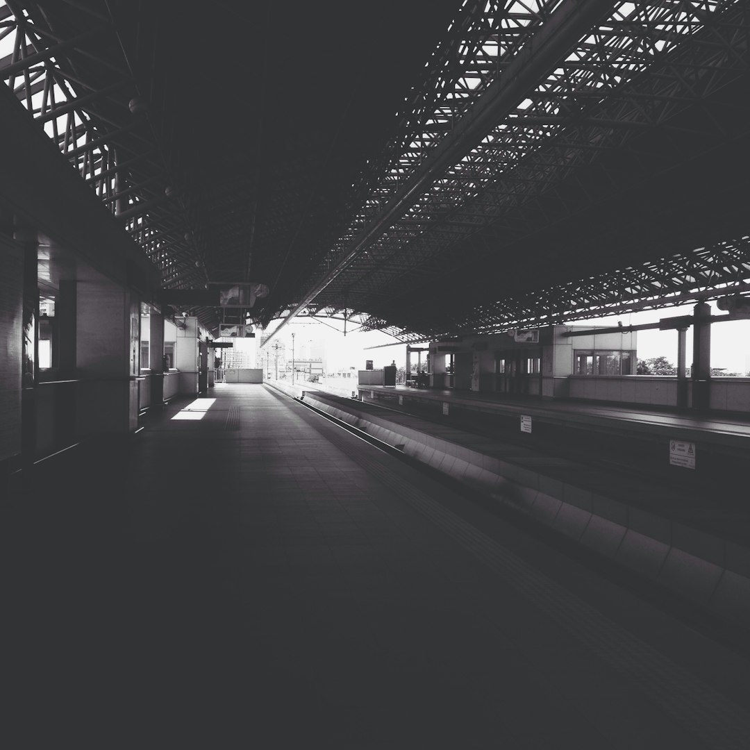 grayscale photography of train railway
