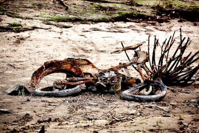 A severely damaged motorcycle with visible parts.