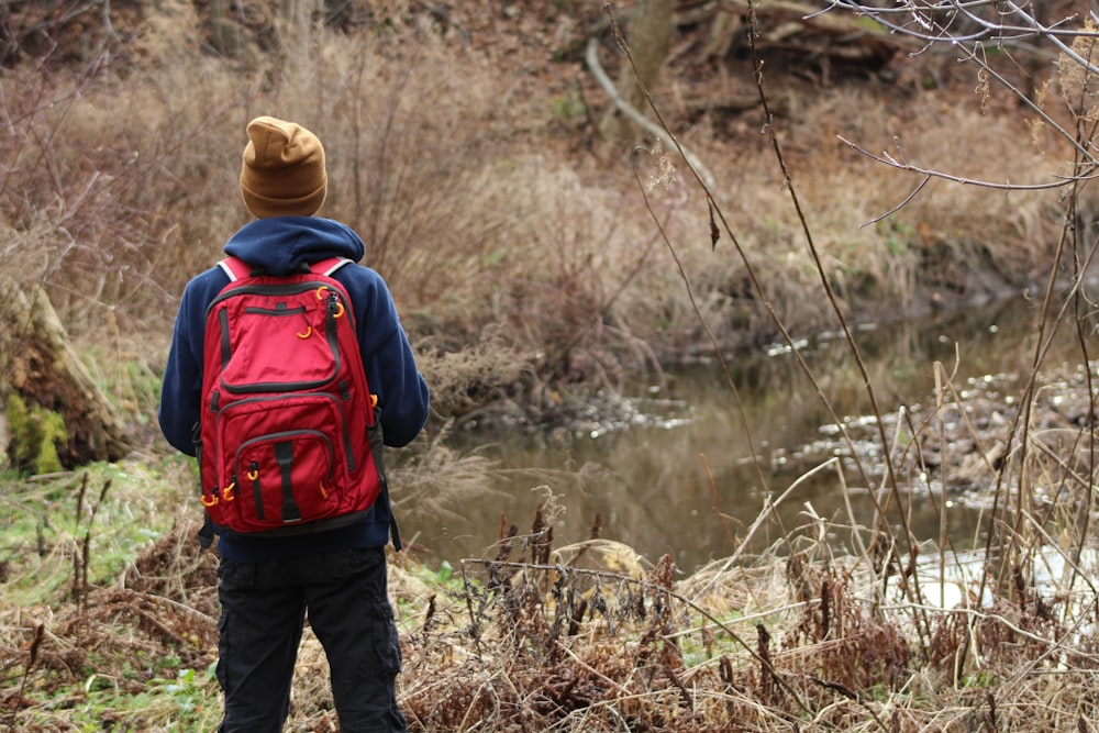 person wearing jacket looking at river