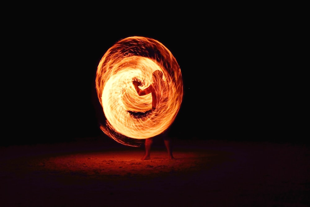 timelapse photography of person fire dancing