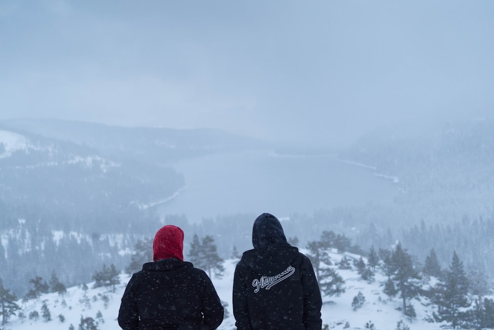 two people sitting on hills