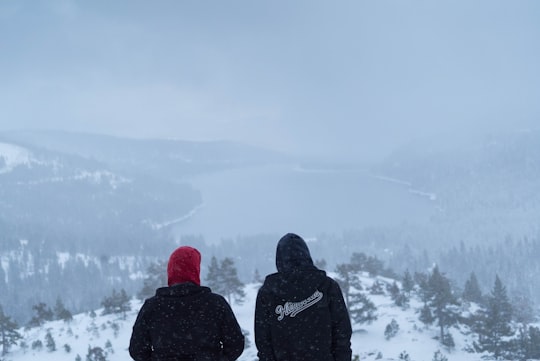 two people sitting on hills in Donner Lake United States