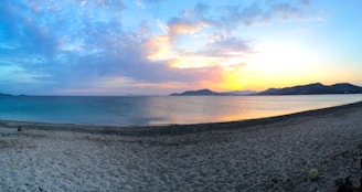Scenic view of a serene beach in Sindhudurg at sunset.