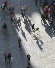 Pedestrians using eco-friendly transport in a city plaza.