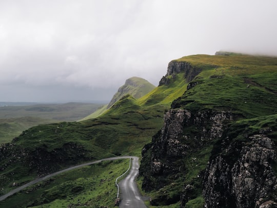 concrete road between mountains in Quiraing United Kingdom