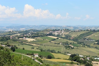 A picturesque landscape of rolling hills with farmland.