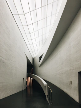Architectural blueprint overlay on a sleek hospital lobby interior.