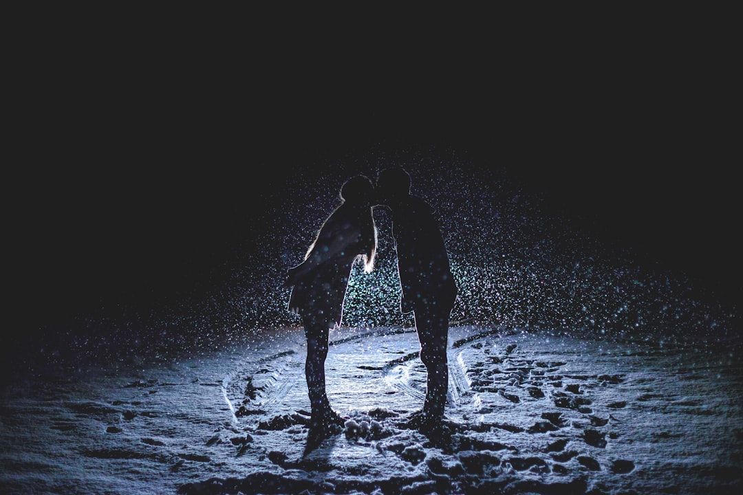 man and woman kissing in the middle of the rain, Backlit by snow