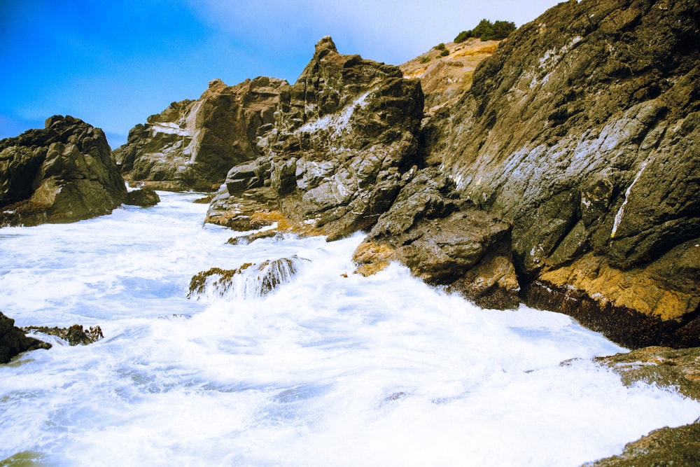 stone formation near body of water during daytime