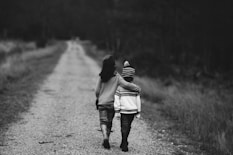 grayscale photography of kids walking on road