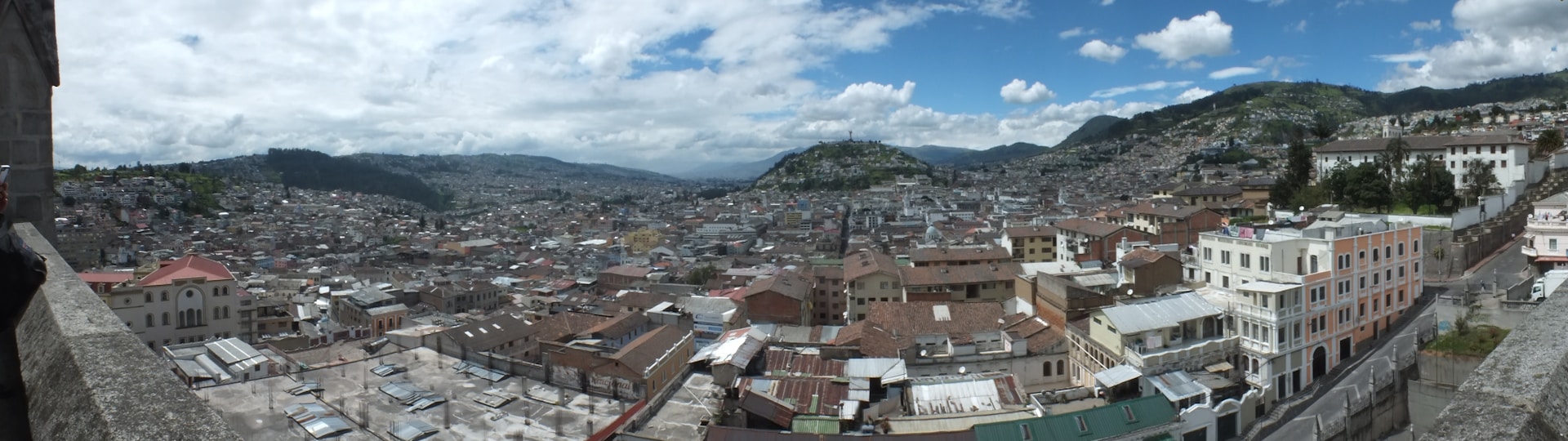 A panoramic view capturing the modern architecture and energetic crowd of CyberHub during a sunny day.