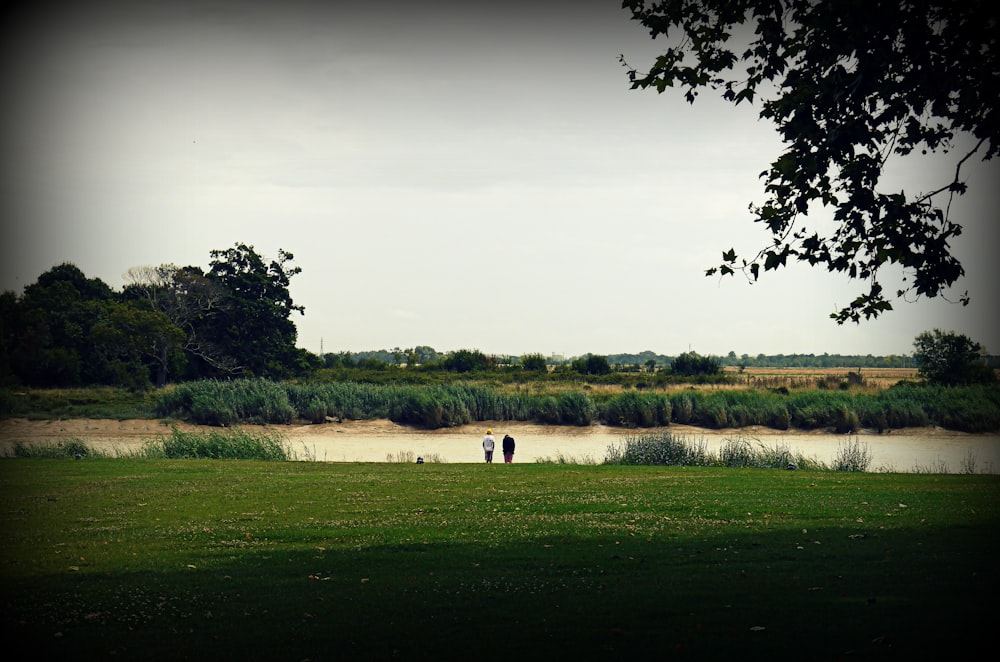 two persons near body of water during daytime