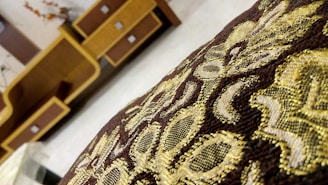 Close-up of a beautifully embroidered pouf showcasing rich textures and vibrant colors typical of Saudi Arabian decor.