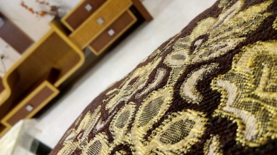 Close-up of a beautifully embroidered pouf showcasing rich textures and vibrant colors typical of Saudi Arabian decor.