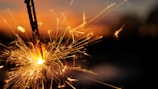 A dynamic shot capturing sparks and smoke swirling around a glowing firework fuse.