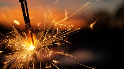 A dynamic shot capturing sparks and smoke swirling around a glowing firework fuse.