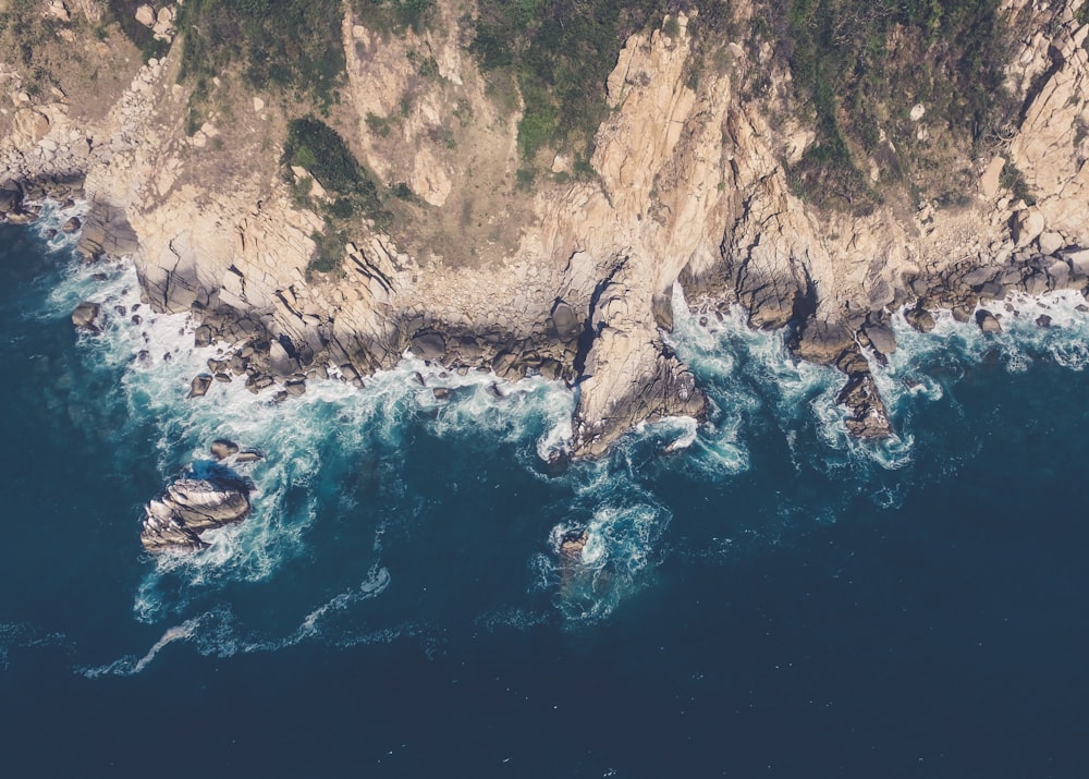 birds-eye view of mountain over body of water