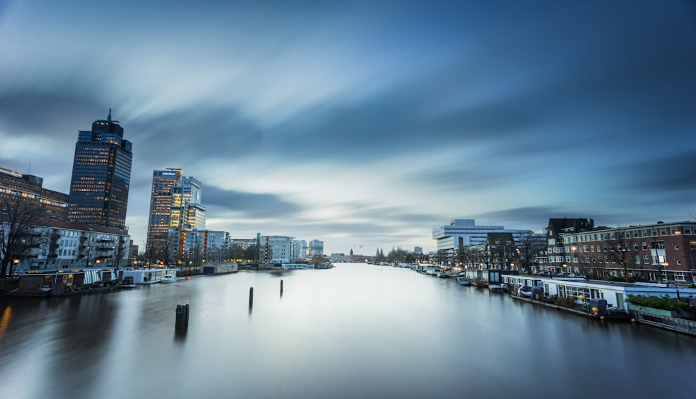 body of water in between high-rise buildings during daytime