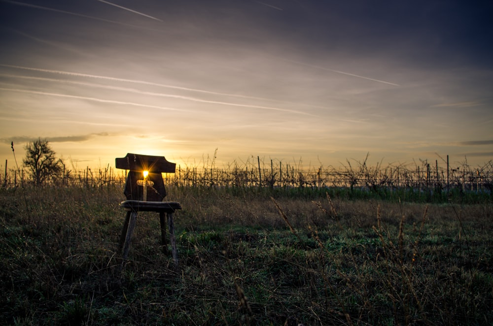 silhouette of a person sitting on a chair during sunset