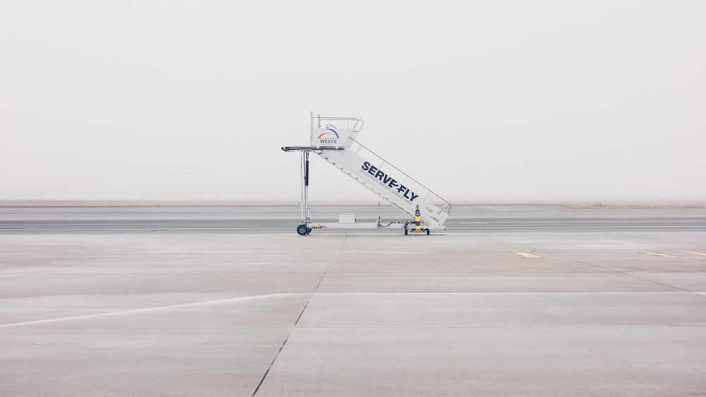 white airliner stairs on runway