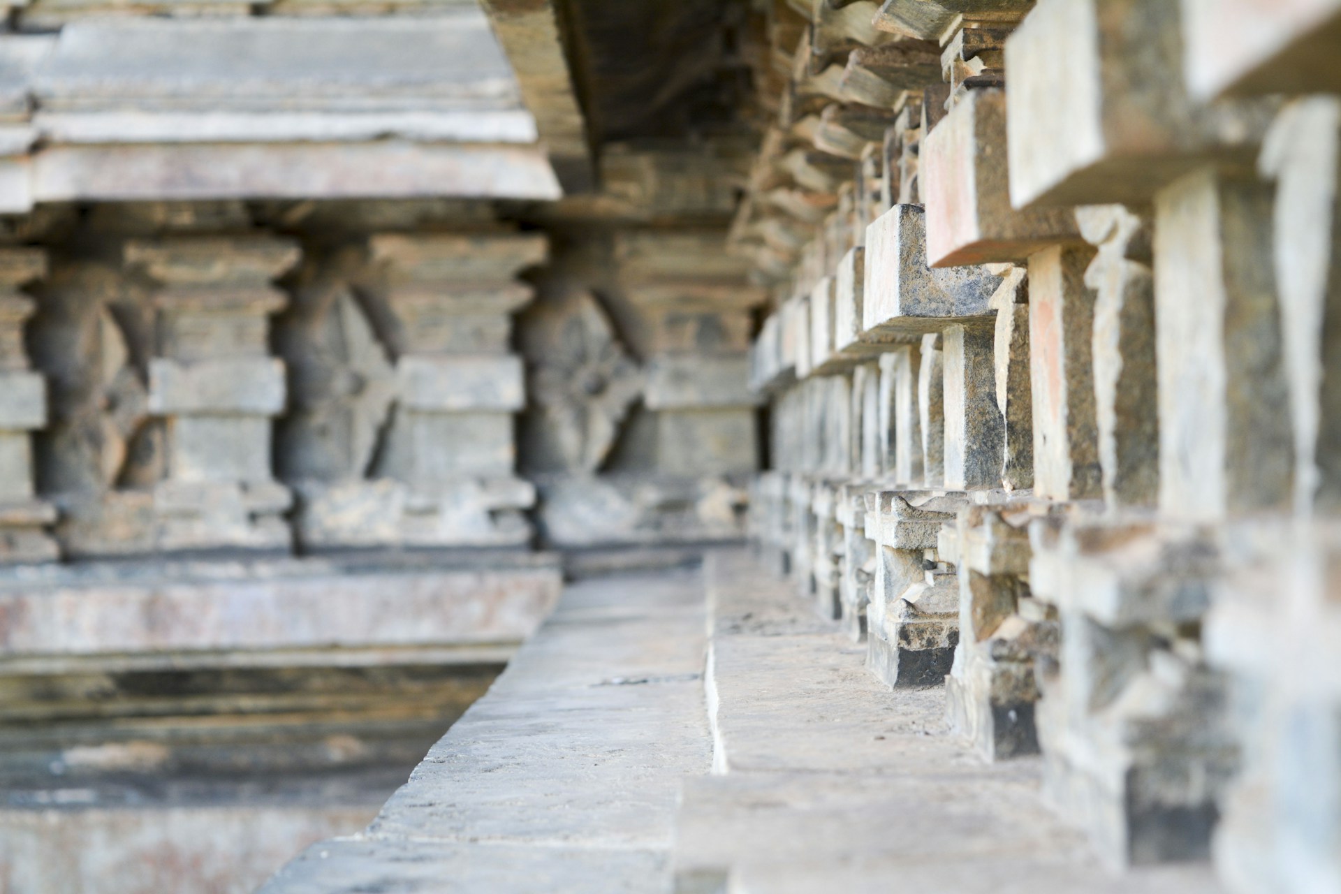 A close-up photo of an ancient megalithic stone with visible carvings, revealing intricate textures under soft natural light.