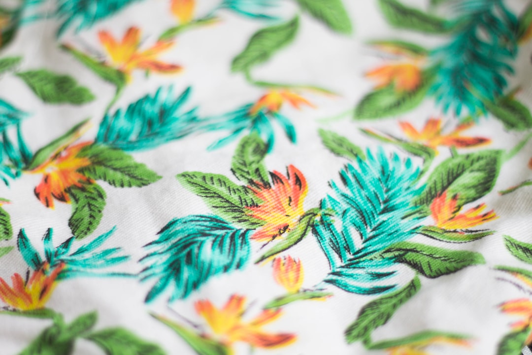white, green, and teal floral textile