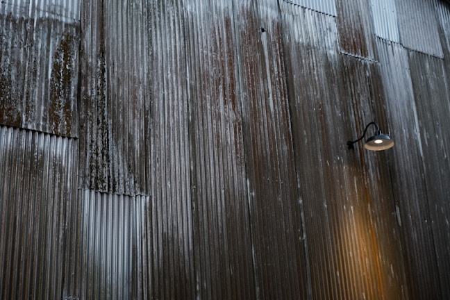 Metal star wall decor with a rustic finish hanging against a warm-toned wall.