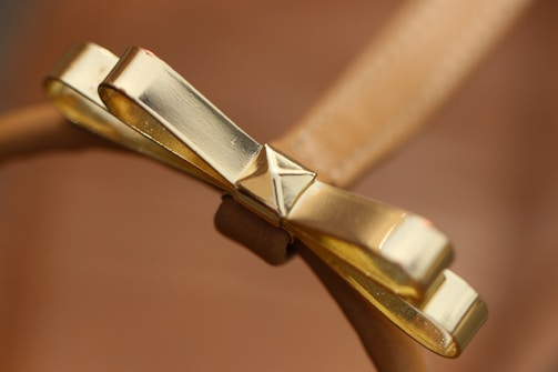 Close-up of a sleek, custom 3D printed decorative object with gold accents on a light background.