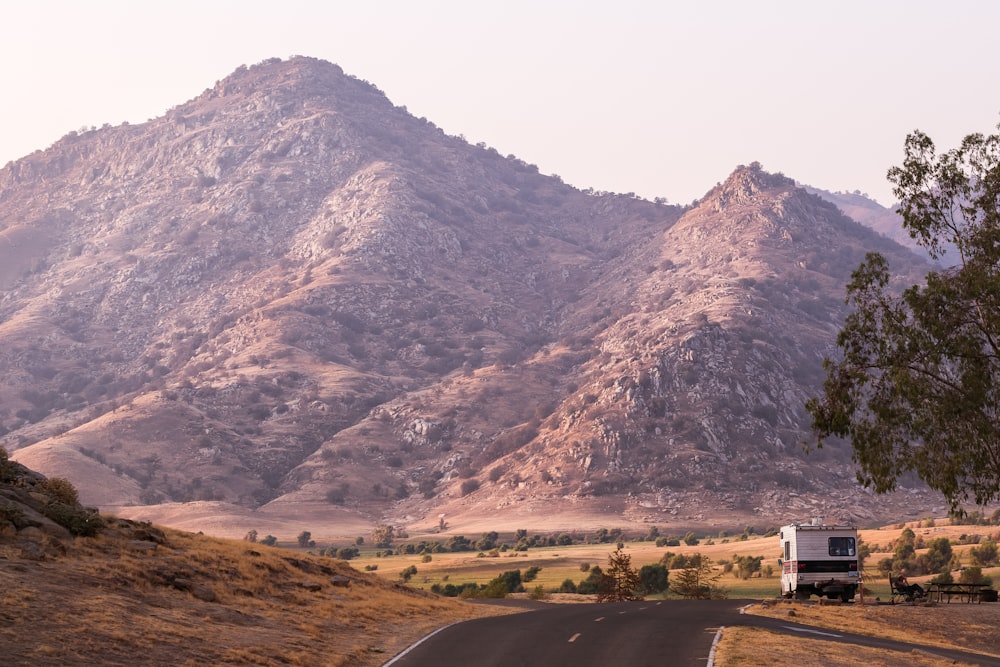 landscape photography of asphalt road in front of mountain