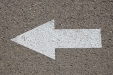 white arrow road sign