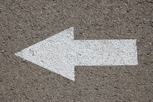 white arrow road sign