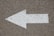 white arrow road sign