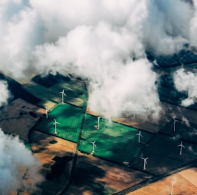 aerial photo of wind turbines near field