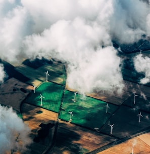 aerial photo of wind turbines near field