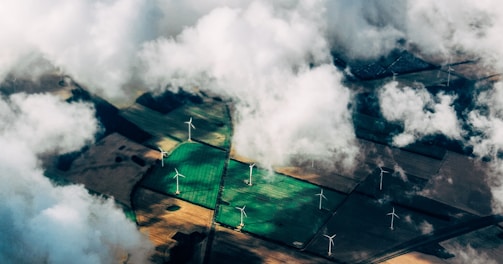 aerial photo of wind turbines near field