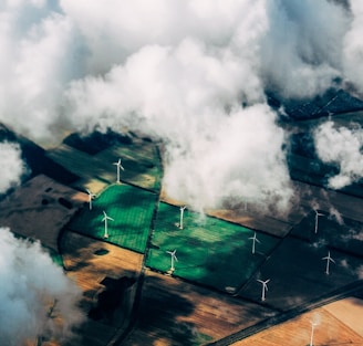 aerial photo of wind turbines near field