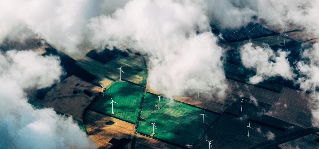aerial photo of wind turbines near field