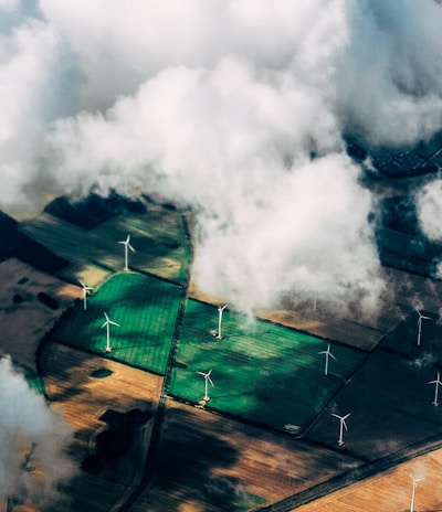 aerial photo of wind turbines near field