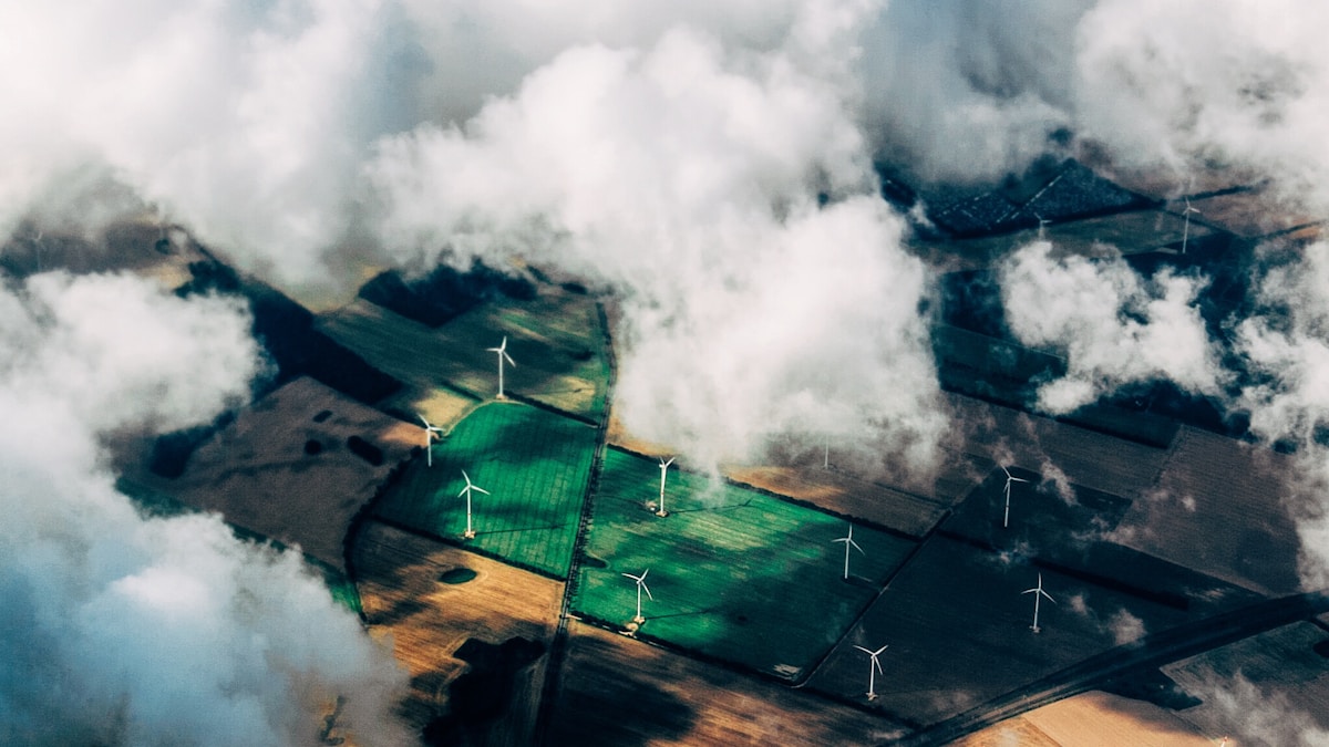 aerial photo of wind turbines near field