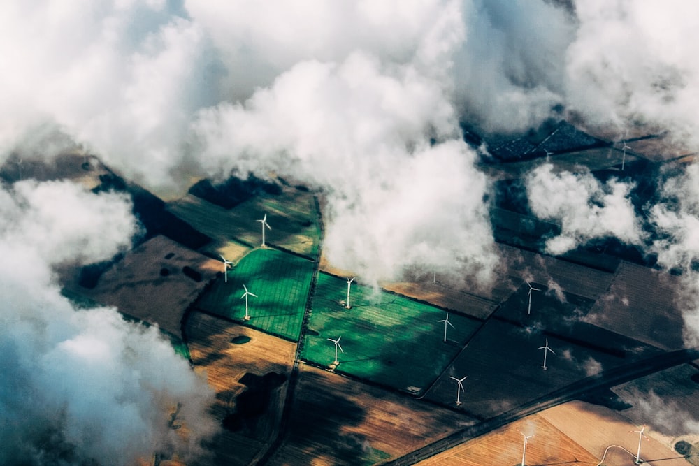 aerial photo of wind turbines near field