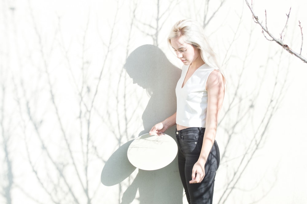 woman leaning on white board