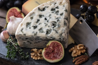 food photography,how to photograph rustic cheese plate; bolognese cheese beside herbs