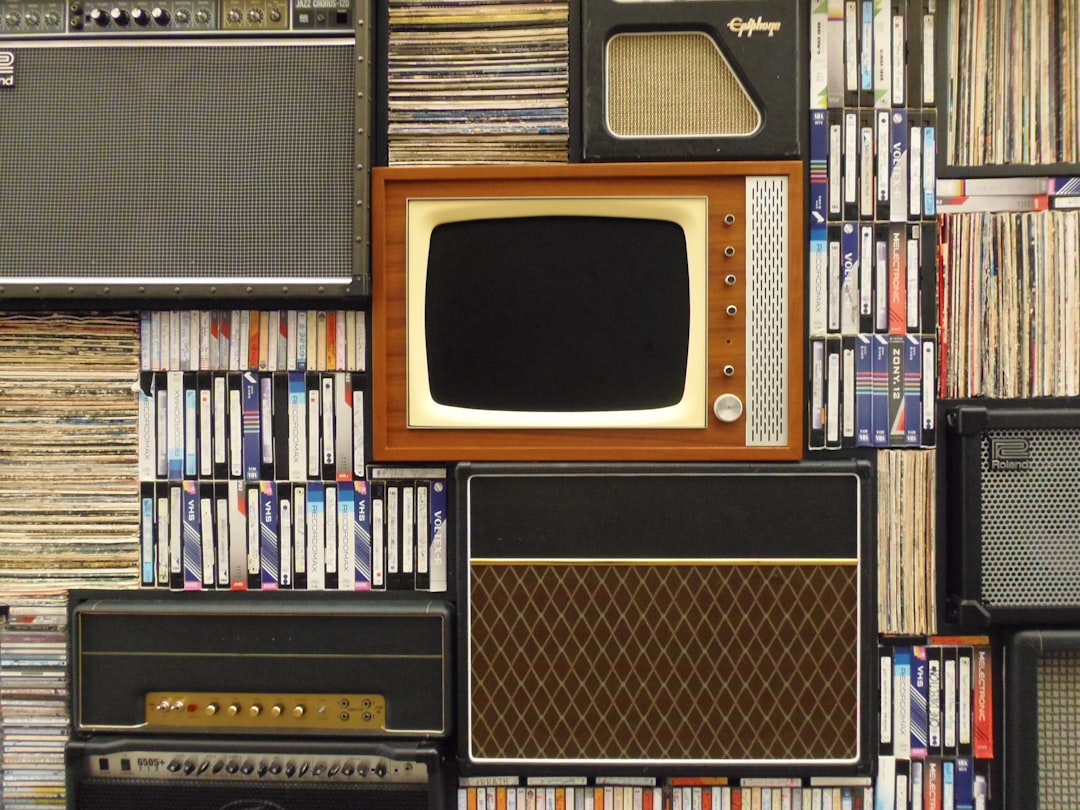 An old television set and several amplifiers among tape cassettes and vinyl records