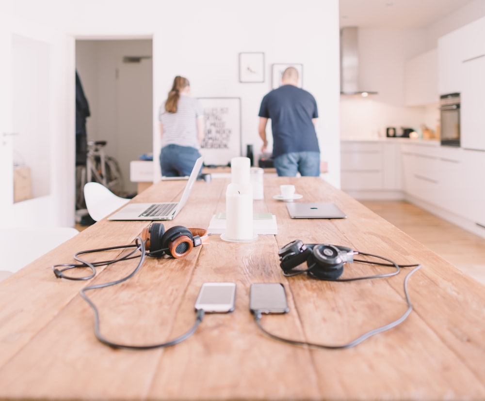 orange and black headphones on table