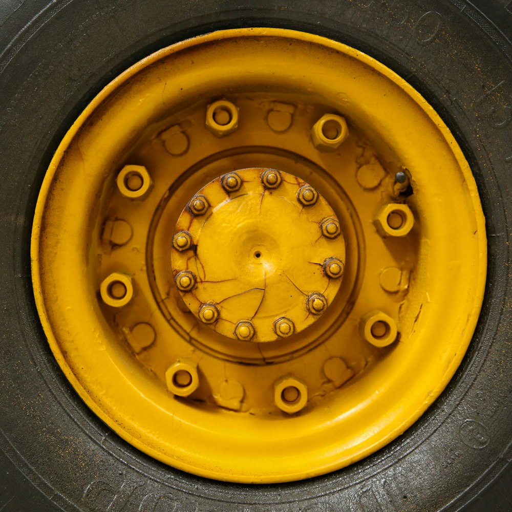 closeup photo of yellow vehicle wheel with tire