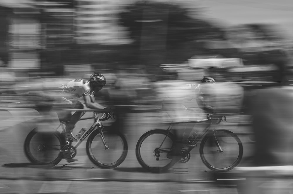 two persons riding on bicycles