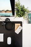 black headphones beside space gray iPhone on brown table